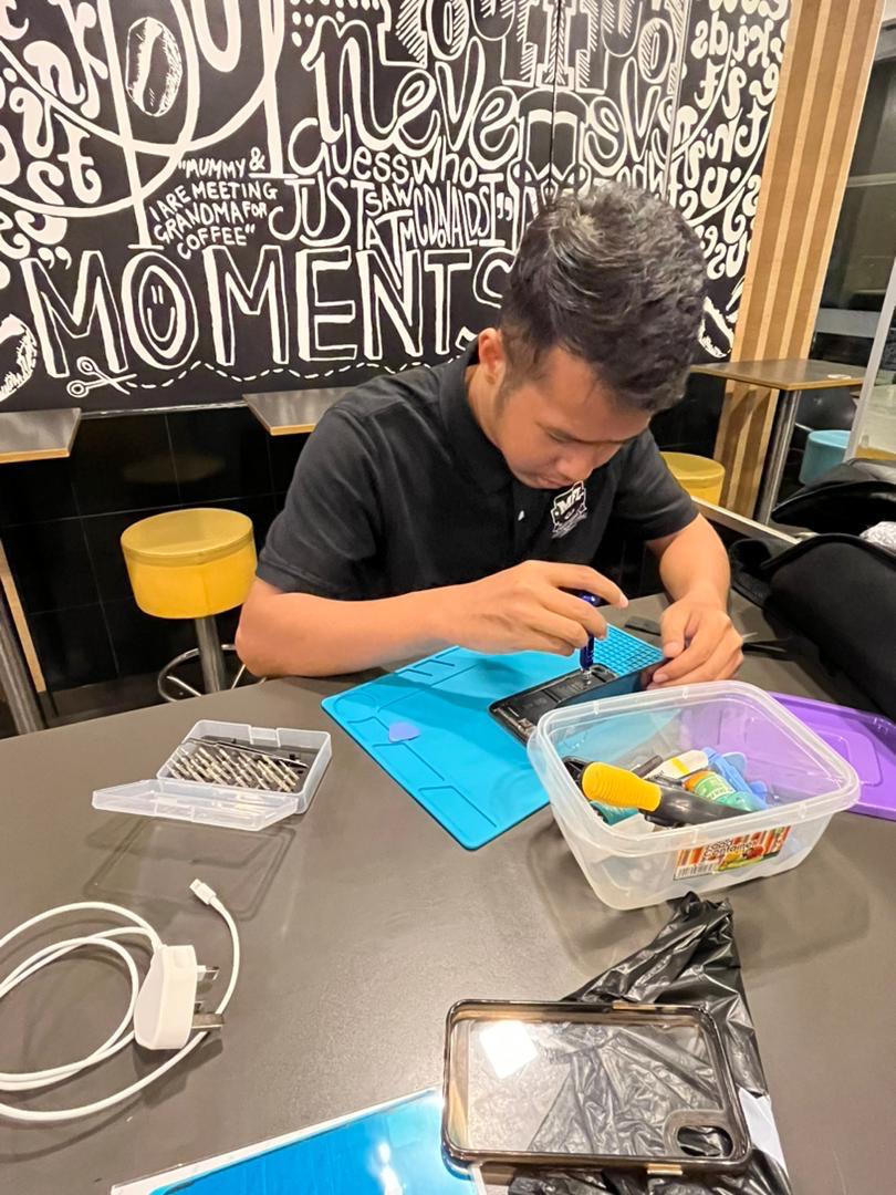 Technician repairing iPhone at MHG